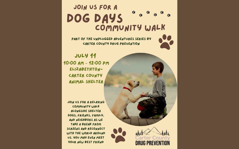 Flyer promoting the Dog Days Community Walk, part of the Unplugged Adventures series by Carter County Drug Prevention. The event will be held on July 11 from 10:00 a.m. to 12:00 p.m. at the Elizabethton-Carter County Animal Shelter. The flyer features a photo of a child kneeling to shake paws with a friendly shelter dog, along with paw print graphics. The event invites families, friends, and neighbors to enjoy a relaxing community walk with shelter dogs, unplug from screens, reconnect with the world around them, and possibly meet a new best friend. The Carter County Drug Prevention logo appears at the bottom.